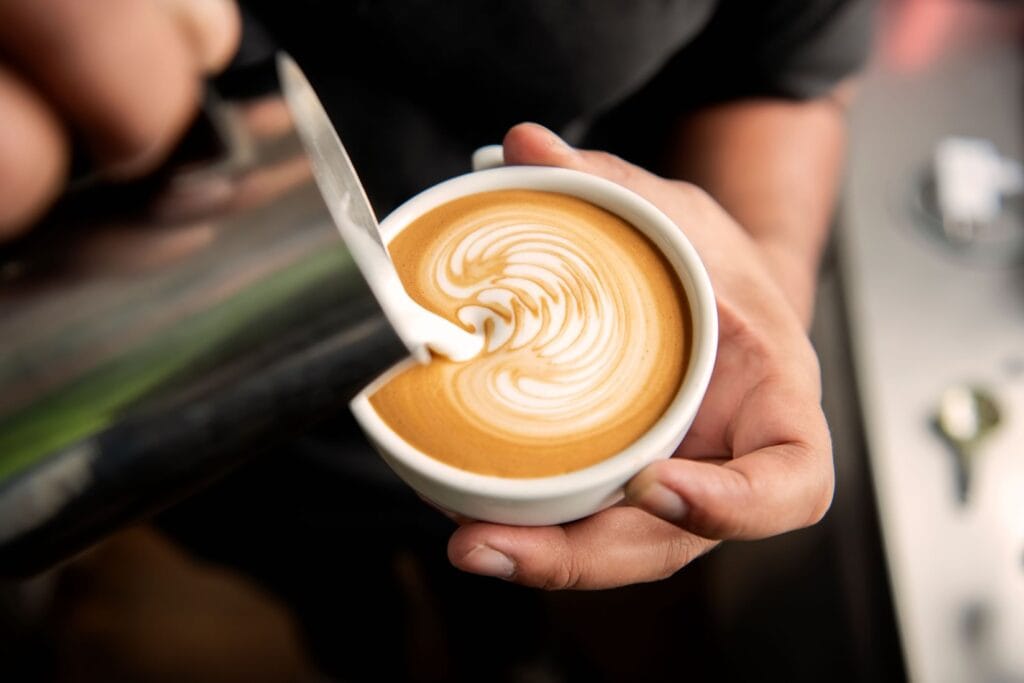 Kilkenny Café barista serving a freshly made cup of coffee